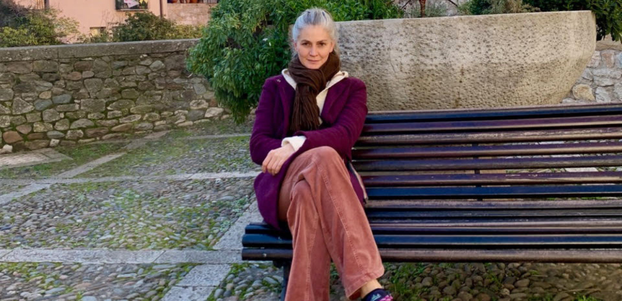A photograph of Maria-Cristina Marinescu sitting on a bench